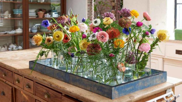 A selection of Ranunculus, Anemone, Leucospermum, Fritillaria, Briza (quaking grass), Fern leaf, and Freesia plants make the perfect recipe for a bouquet of colour. Photo: Van der Plas.