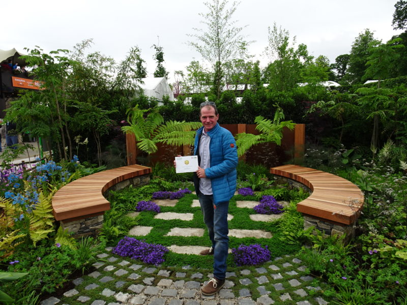 John Durston in his show garden with his gold medal award from Bloom 2017