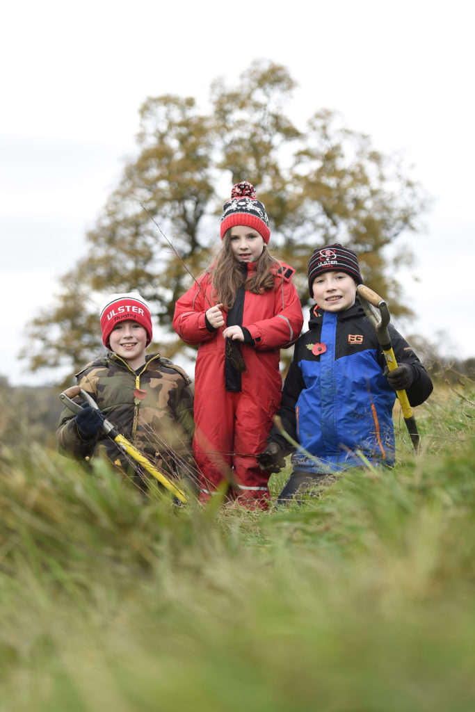 L-R: Patrick, Eden and Isaac make their mark at Brackfield Wood, near Derry/Londonderry. Photo: Michael Cooper