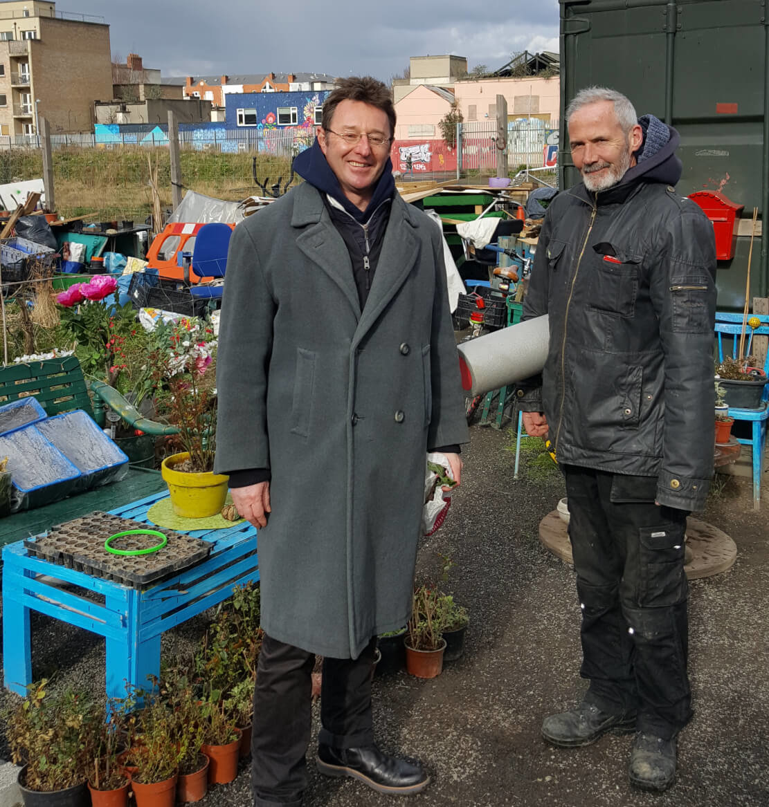Bridgefoot Street Community Gardeners Robert Moss and Richard Taplin brave the hail showers at lunch time to meet with Lisa from the Guinness Enterprise Centre. Photo: Lisa Doyle.